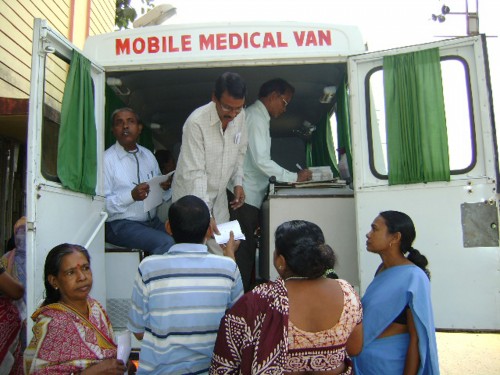 The Community Development Society (CDS) women with patients at the mobile medical van.