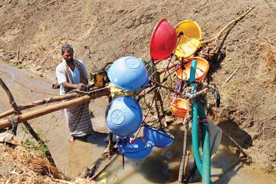 An illiterate Farmer designs a Water Mill to generate Electricity