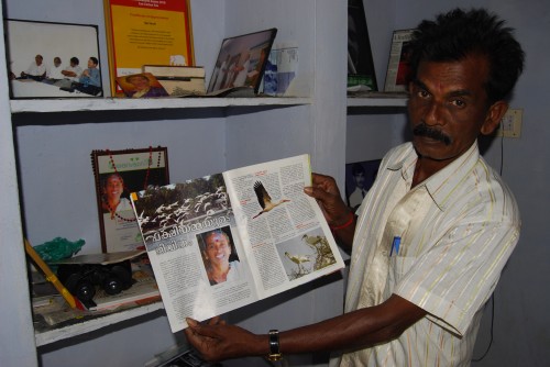 Bal Pandian proudly showing an article on his late wife, Vallithai Pandian