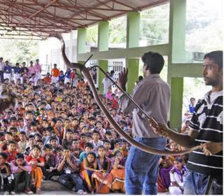 Volunteers educating children about snakes