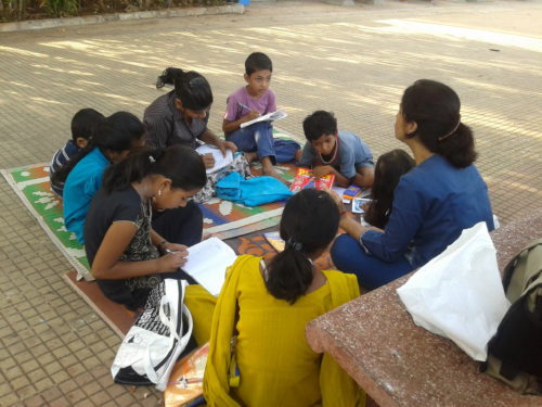 A volunteer teaching children at Carter Road