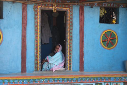 A tribal woman sitting at her door in Purushwadi