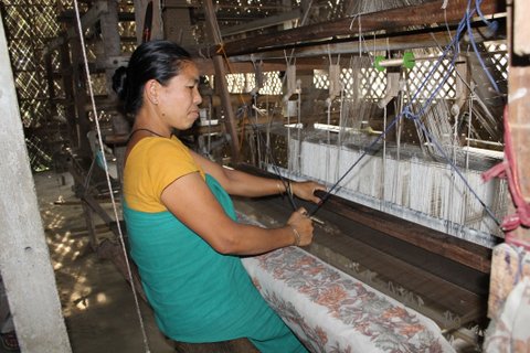 Miri, an Assamese woman from the nearby hills, weaving magical patterns into the silk saree at Sualkuchi