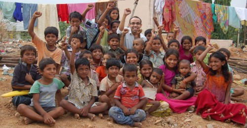 Mr. Satish Sikha with the children after a distribution drive of free biscuits