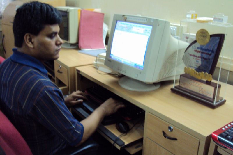 Pradip using the computer with the help of electronic braille reader
