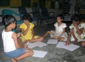 The children are enthused by the story and get down to drawing some of their own Kolams!