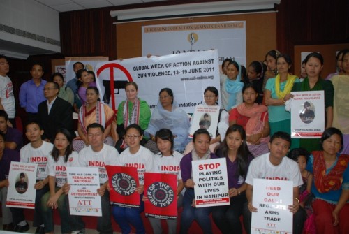  Women of the network at a meeting, holding photographs of the sons and husbands they have lost in gun violence in Manipur. (Credit: Azera Rahman\WFS)