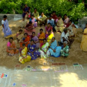 Local self help group members in Rangareddy Palayam village draw a local map on the main street, marking disaster-prone spots as part of a risk assessment exercise. Source: Trust.org