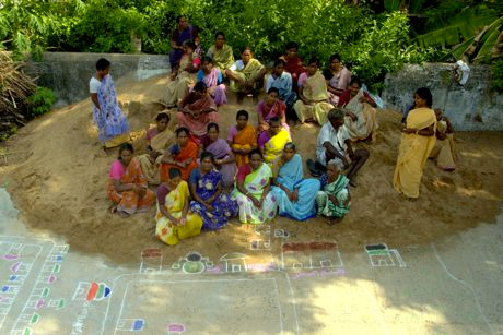 Local self help group members in Rangareddy Palayam village draw a local map on the main street, marking disaster-prone spots as part of a risk assessment exercise. Source: Trust.org