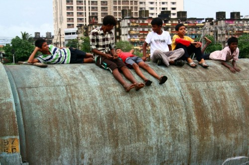 Kids relaxing near the pipeline – a place where they have lived and enjoyed