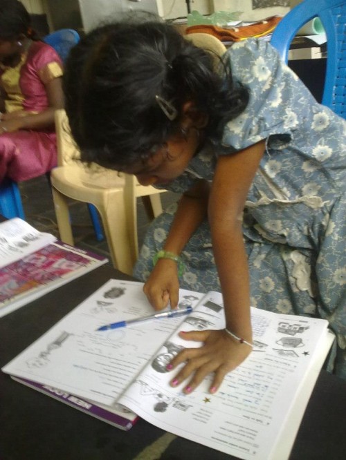 A girl from Childrens home centre in Injambakkam,Chennai, working on her workbook in MAD class