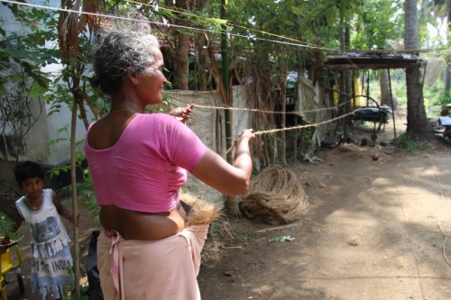 A lady spinning a coir yarn.