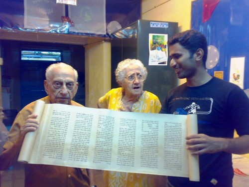 Thoufeek Zakariyah, Sarah Cohen and Isaac Ashkenazi inspecting a Torah that Thoufeek designed.