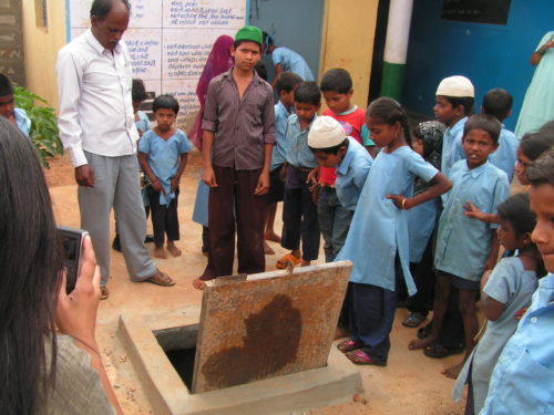 Biome Environmental - Children with the rainwater storage sump 