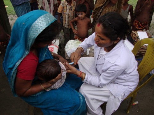 An ANM immunises a child in a health camp organised by the boat clinic in the Nalbari district of Assam. 