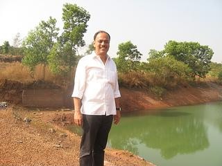 Rajesh Naik near the lake he has developed at the Oddoor farms near Mangalore