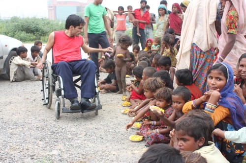 Navin Gulia with some of the street children he supports through his initiative - Apni Duniya Apna Ashiana