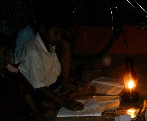 Child Studying using a Kerosene lamp