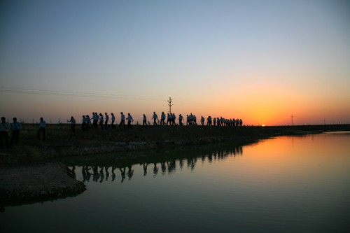 The students of AIM walking along one of the lakes
