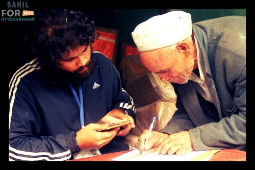 A volunteer gets a signature of the villager after he has collected the relief supplies