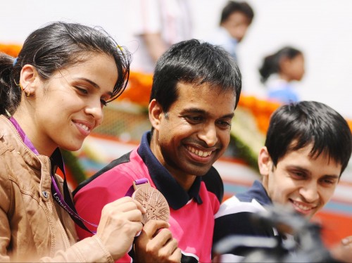 Pullela Gopichand with Saina Nehwal after winning the Olympic medal
