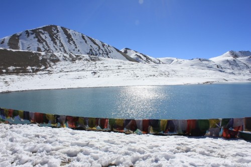 The pristine Lake Gurudongmar lined with prayer flags on one side