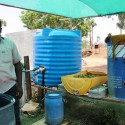 Alagesan with the barrel used to ferment cow dung