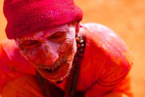 A Sadhu soaking in the sun after a gulaal session.