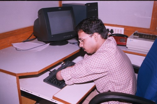 Raja at his desk at ONGC, where he can efficiently work on the computer as well