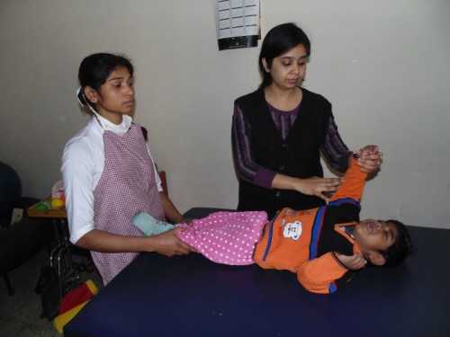 Therapist checking a child at Bal Chetna-DCCW’s respite Home and Day-care facility for mentally challenged children