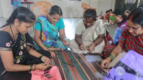 Women making fashion jewellery products in the training organised by Srujna
