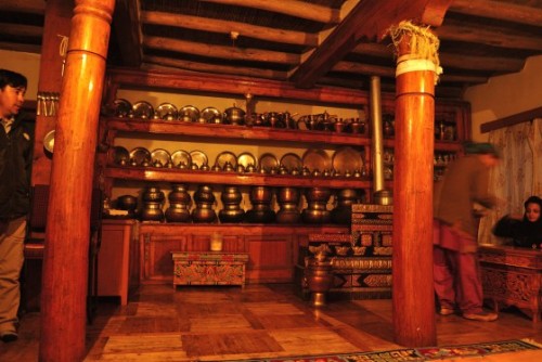 The Ladakhi Kitchen. The cooking area is on the floor to the right, embellished with motifs.
