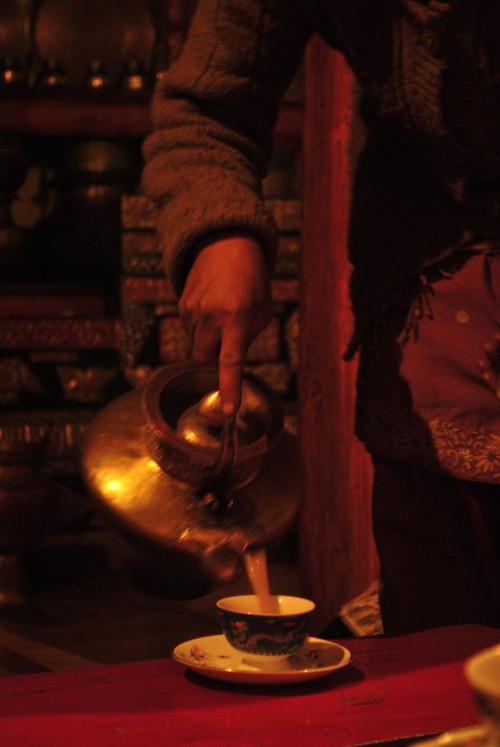 Our Ladakhi host serving us Solja before a dinner of Momos, soup, spinach and wheat dumplings curry, pulao and apricots. The cups are Bone China, smuggled over from the Chinese border and sold at Rs.50 each.