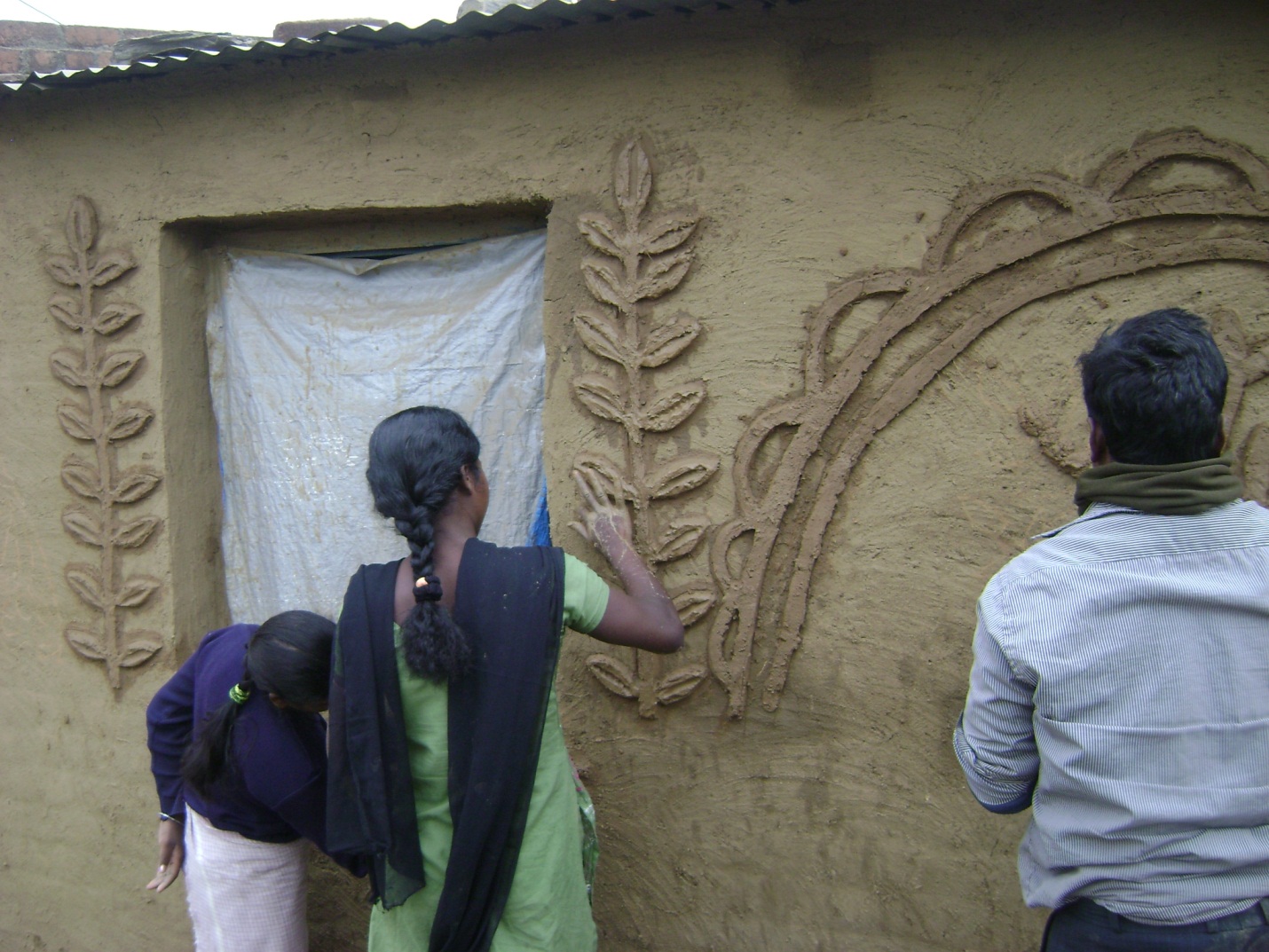 Display of art work on the walls of the community hall by the Santhals