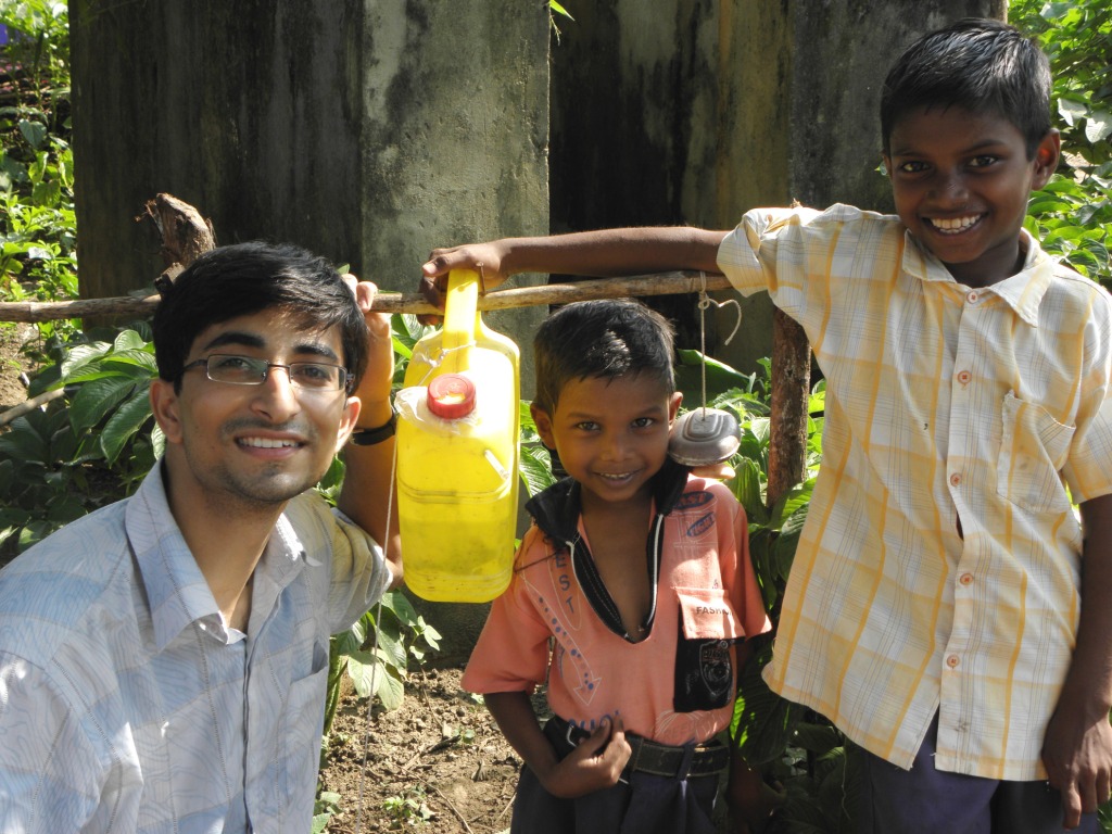 Pawan and kids with Nirman, a low-cost hand washing device.