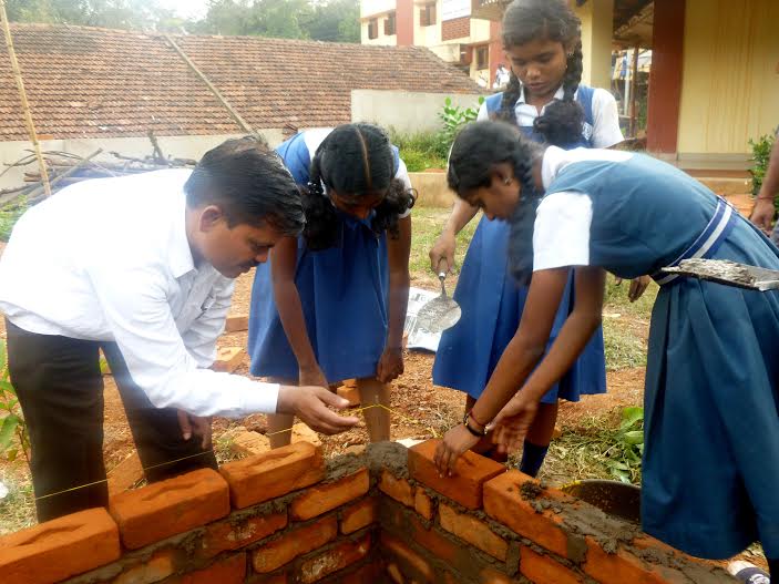 Students learning to lay bricks in construction training.