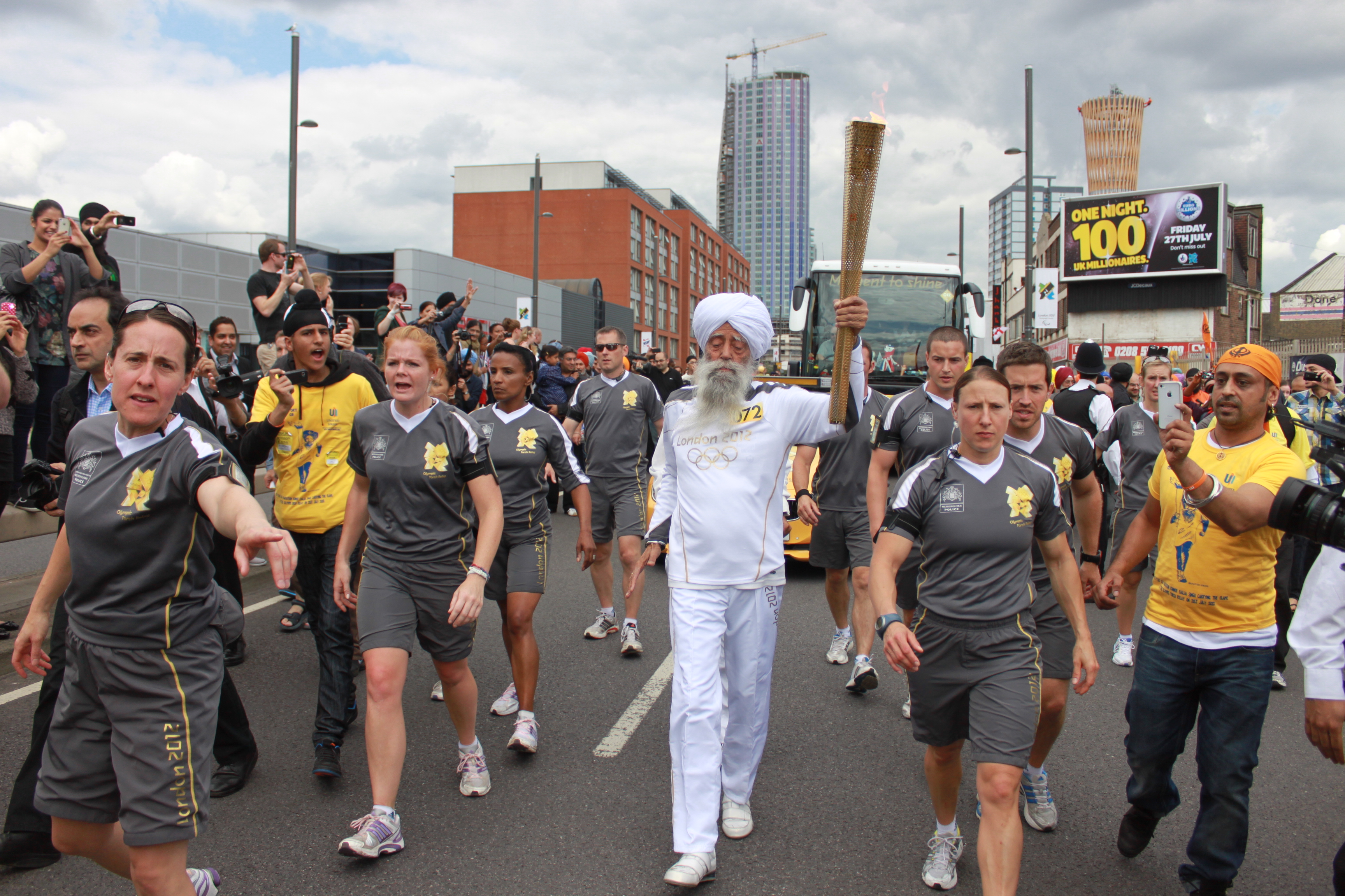 Fauja Singh running with the Olympic torch at the 2012 London Olympics