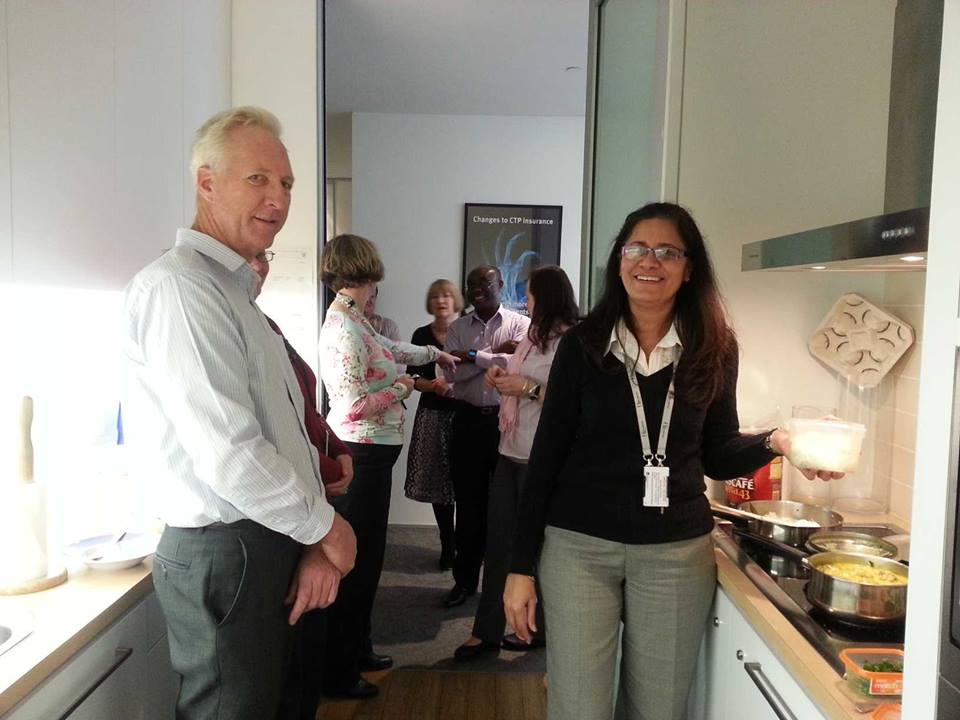 Nandita's office colleagues queuing up for her rice and curry lunch