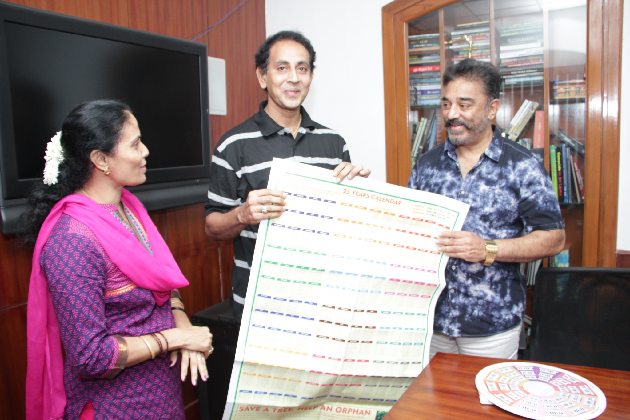 Ramesh and Sridevi showing the 25-year calender to Kamal Hassan