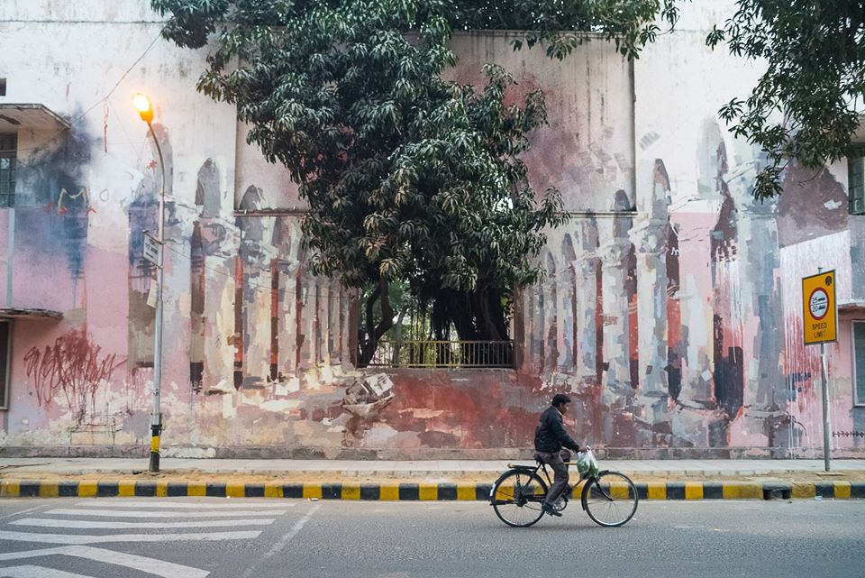 "The Origin of the World by Borondo. Since this wall is located opposite a maternity hospital, Borondo, in his signature abstract style, interprets the concepts of life and birth. The open arch in the middle of the wall and the tree which inhabits it are a metaphor for the origin - the source of life, while a river flows through the arches into infinity with a boat on it which reflects the journey of life."