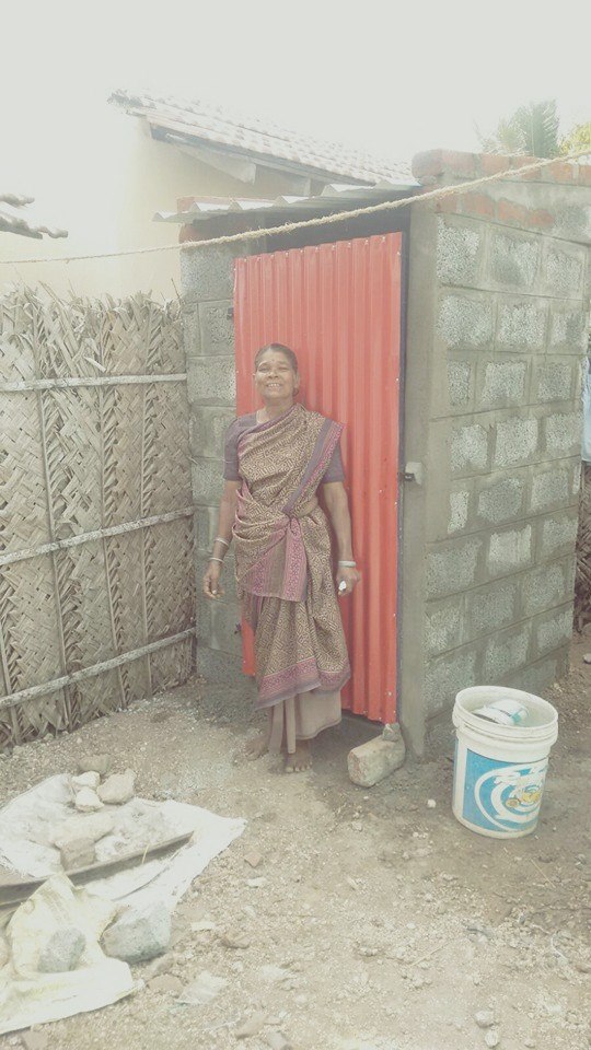 A happy beneficiary of the Toilet First initiative