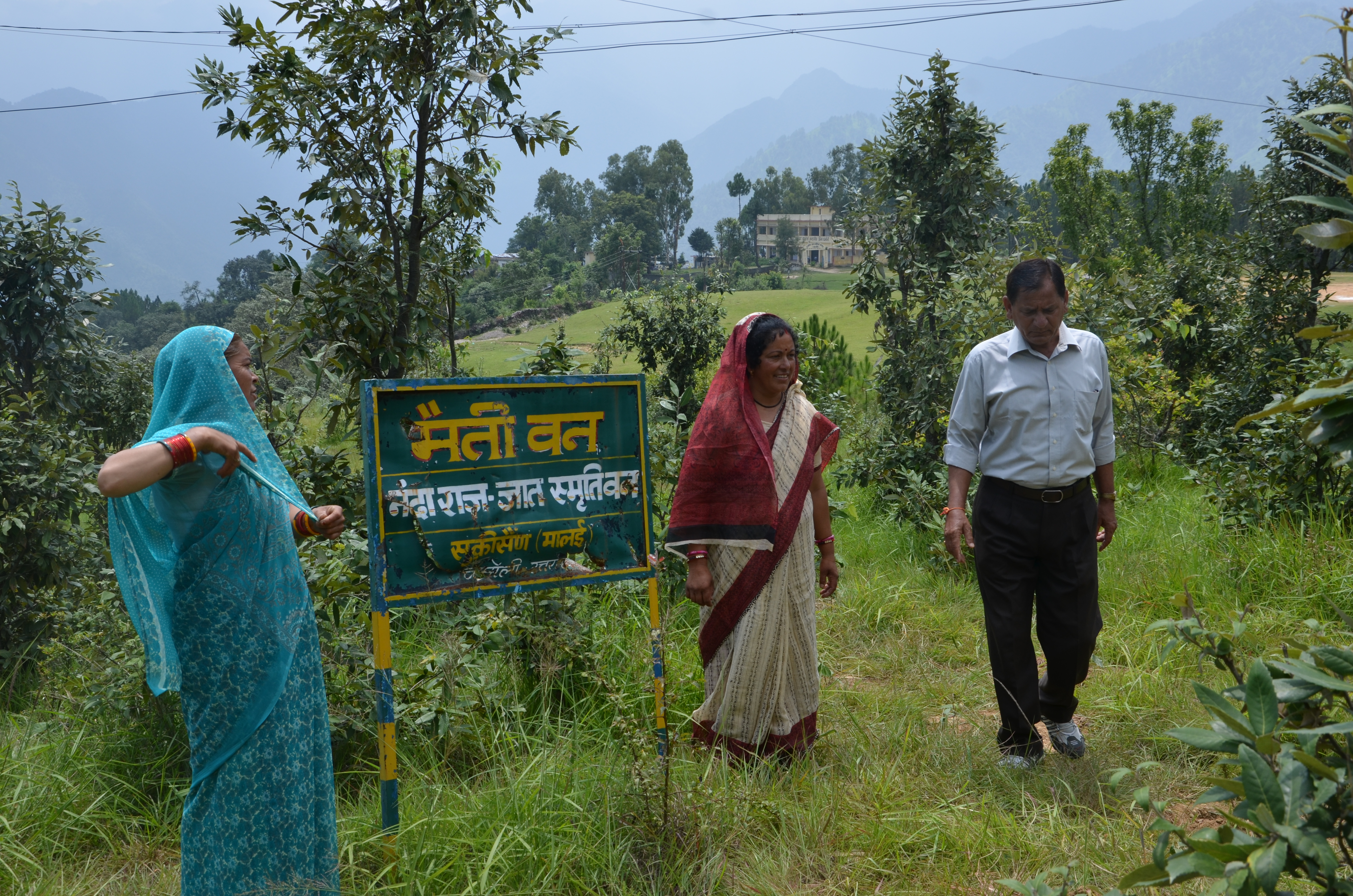 Sulochana (left) and Devaki (middle) with Kalyan Singh at the 'Maiti Van' near their Bagoli village in Chamoli district. It was Singh who started this unique tree plantation drive. (Credit: Nitin Jugran Bahuguna\WFS)