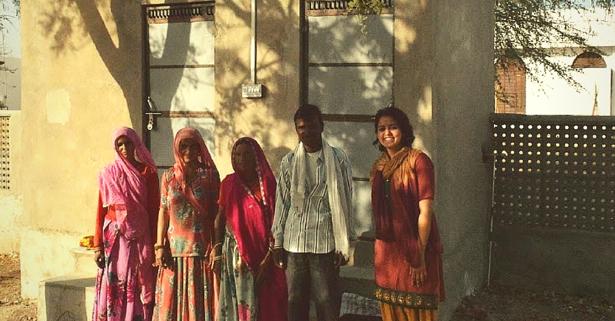 Suriya with labourers outside the pilot toilet in TIlonia