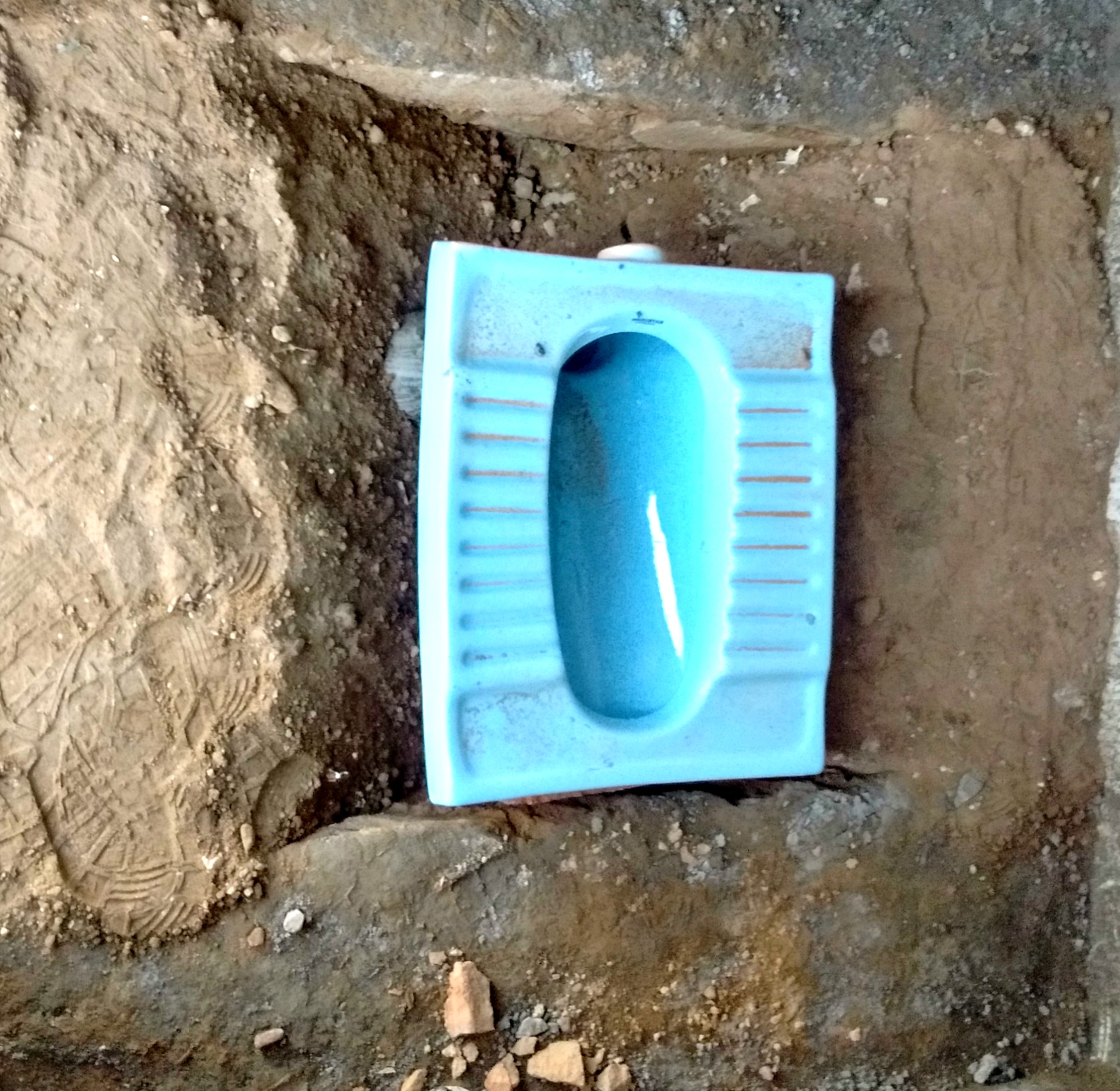 Laying of the 'deep rural' toilet pan at Kotri