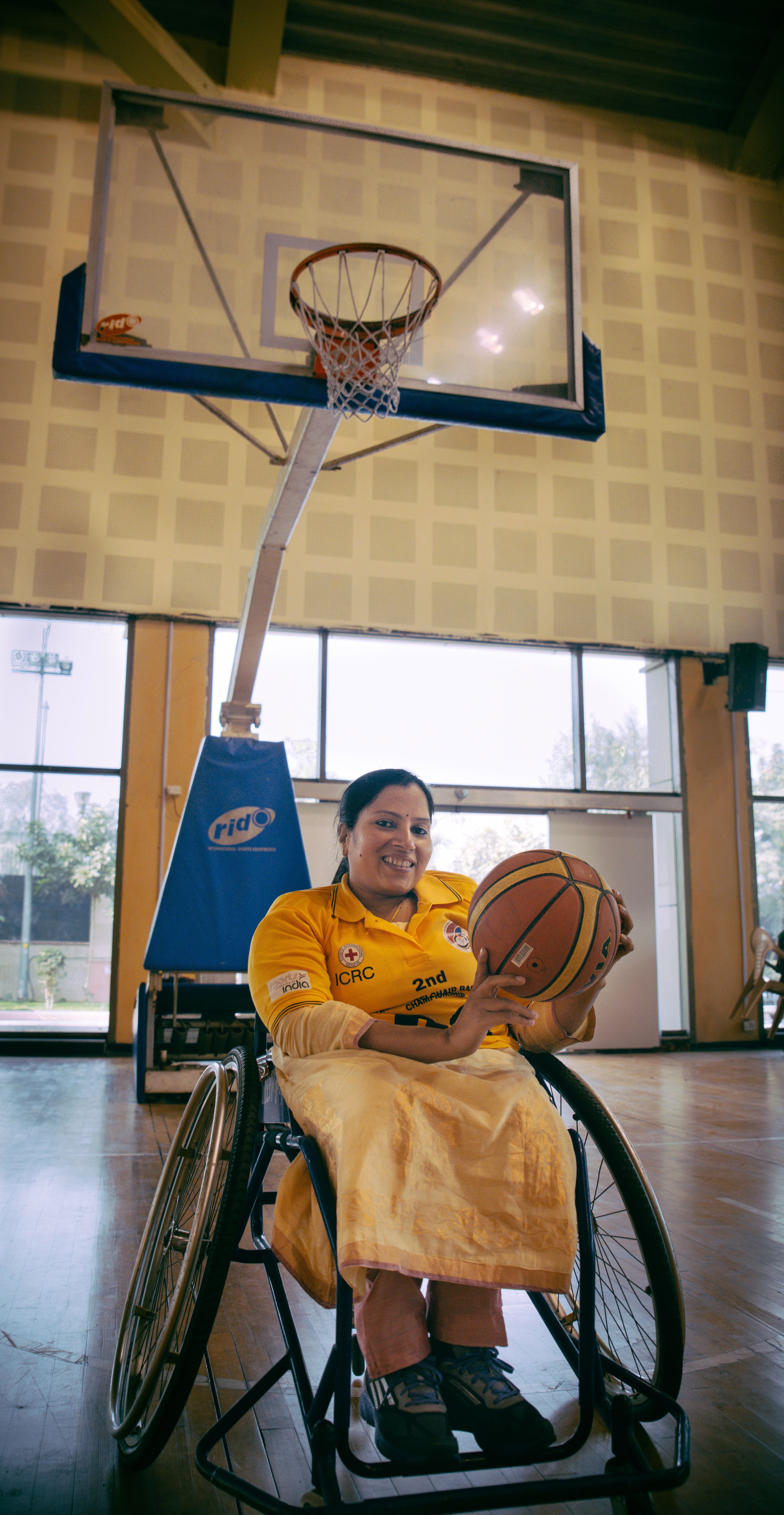 Madhavi poses with the basketball before her first game as a wheelchair basketball player.