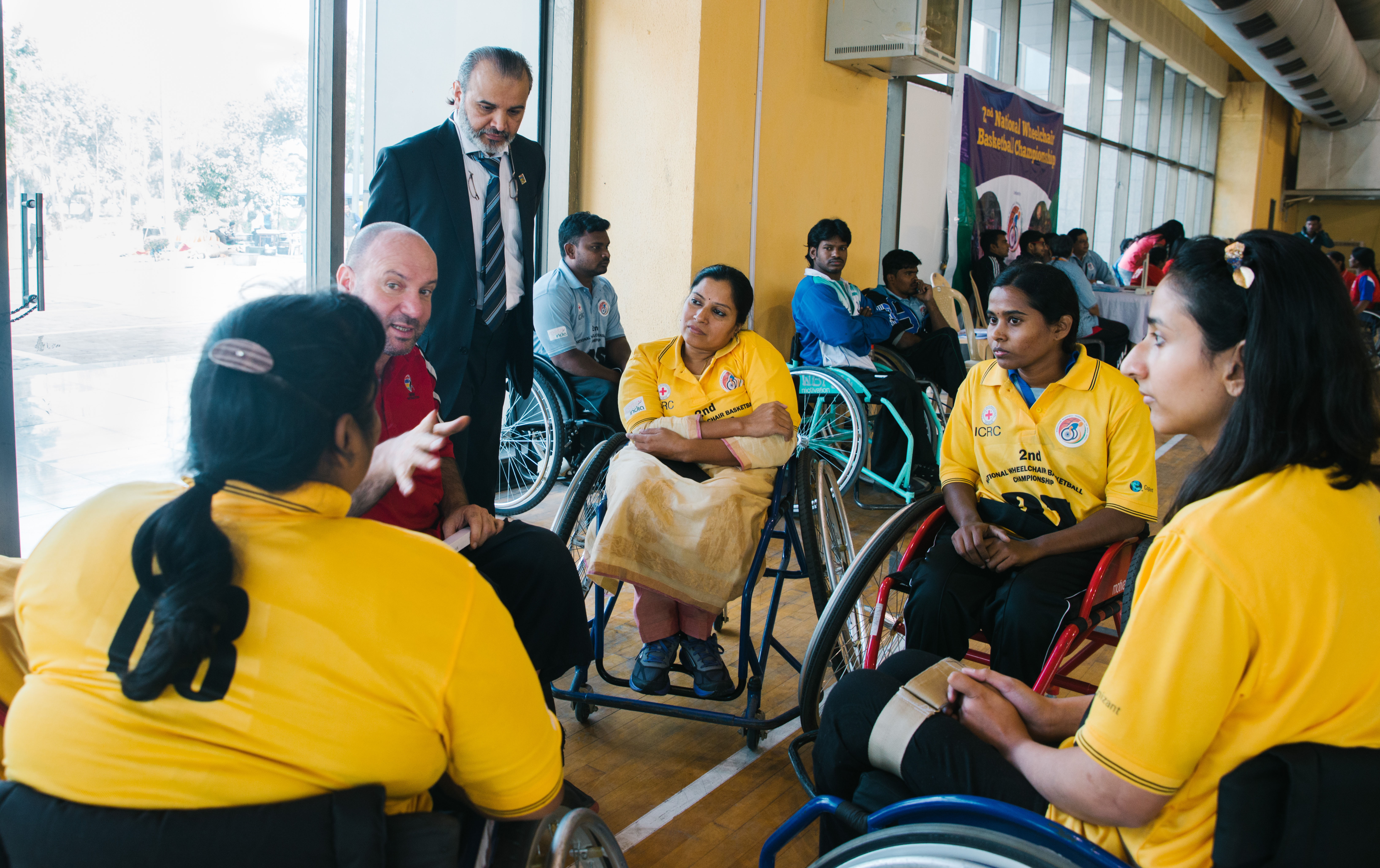 Madhavi with the first women’s team at the National Wheelchair Basketball Tournament, pay attention to their coach during a timeout amidst the match.