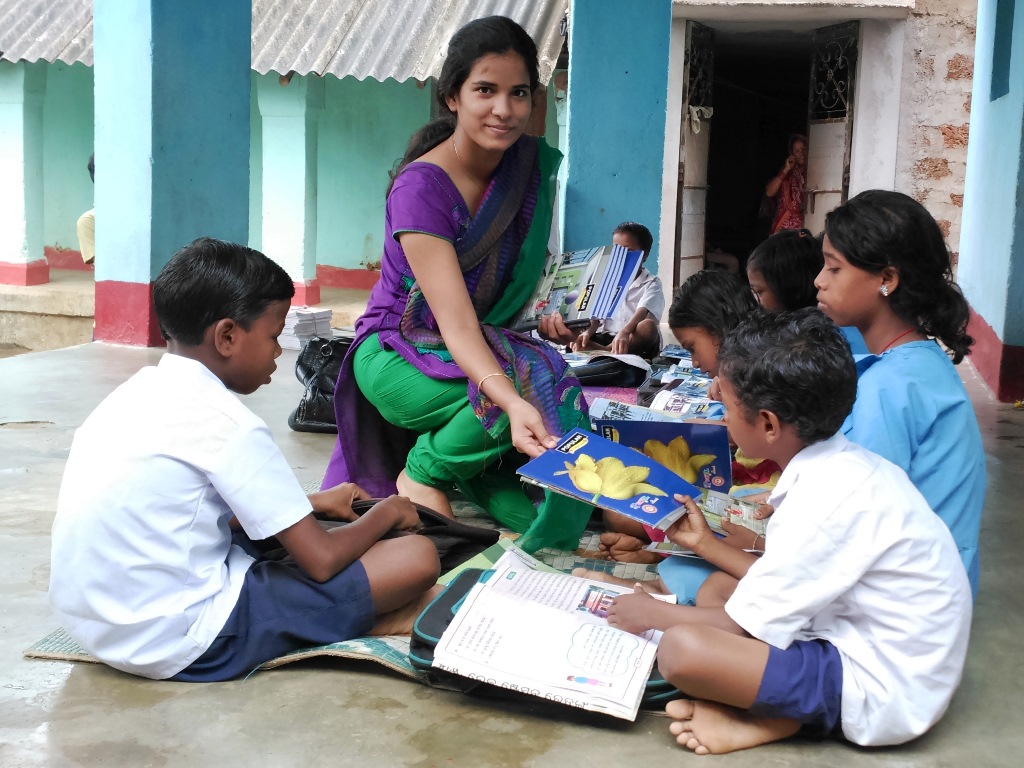 Maya distributing school supplies to underprivileged children