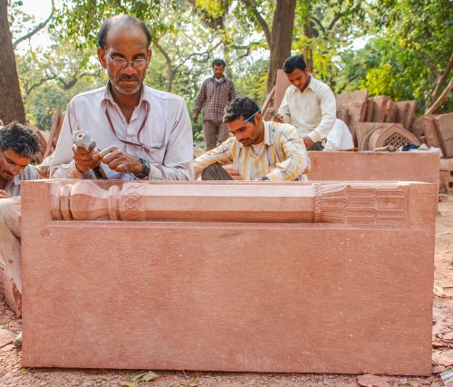 Skilled craftsmen working with traditional tools and materials