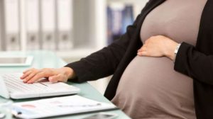 Pregnant businesswoman working on a laptop