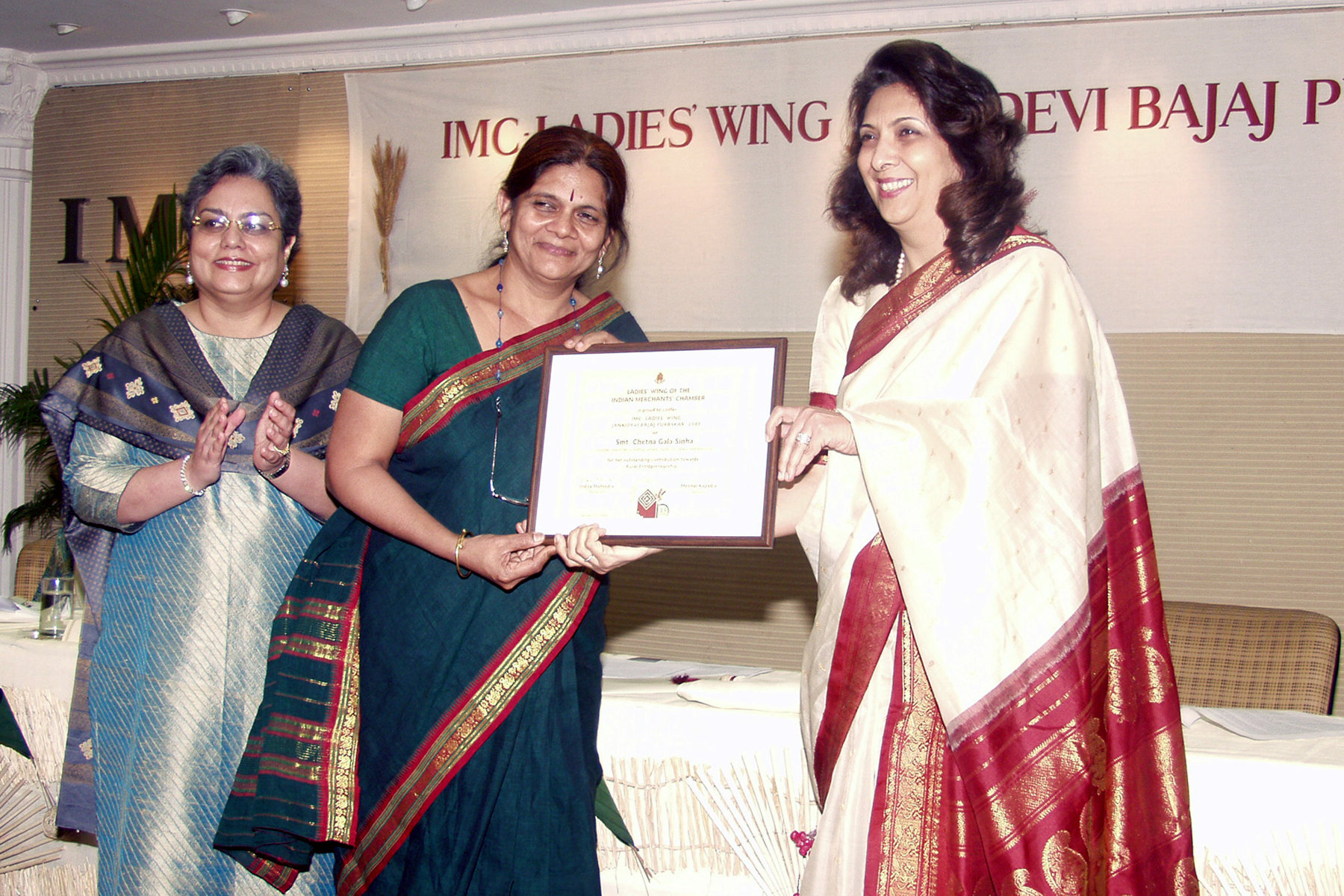 Smt. Chetna Gala Sinha receiving 13th IMC-LW Jankidevi Bajaj Puraskar -2005 from Dr. Indu Shahani, Principal, H.R.College. Dr. Meenal Kapadia, President IMC-LW looks on.